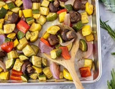 Spoonful of Oven Roasted Vegetables on a pan.