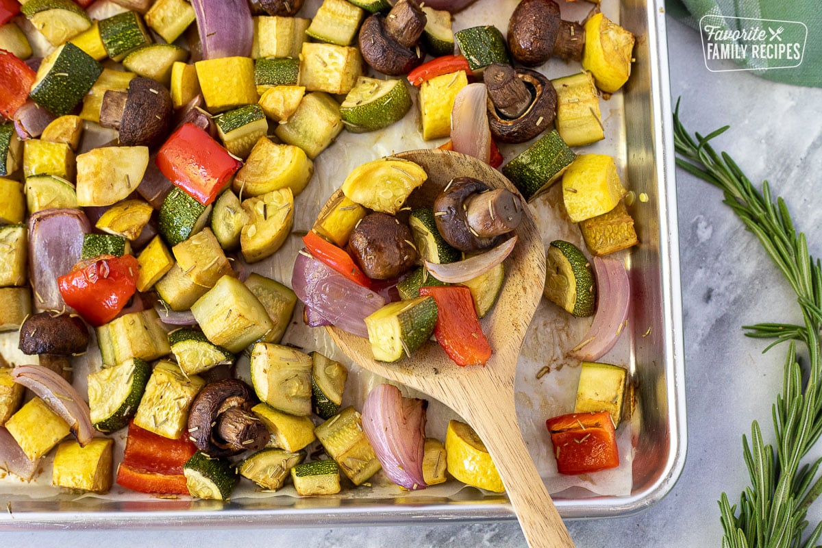 Spoonful of Oven Roasted Vegetables on a pan.