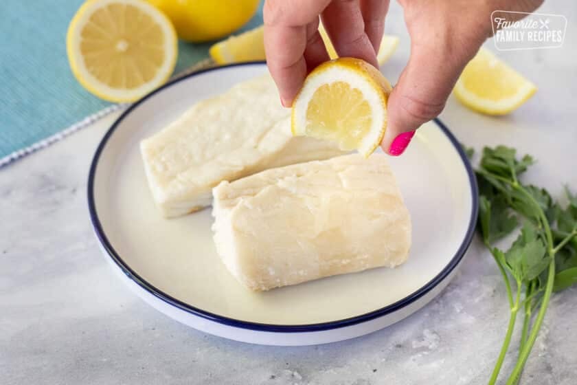 Squeezing lemons on cooked halibut for Poor Man's Lobster.