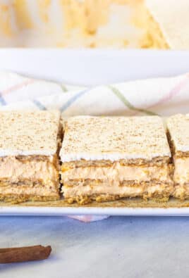 Three slices of Pumpkin Eclair Cake lined up on a plate.