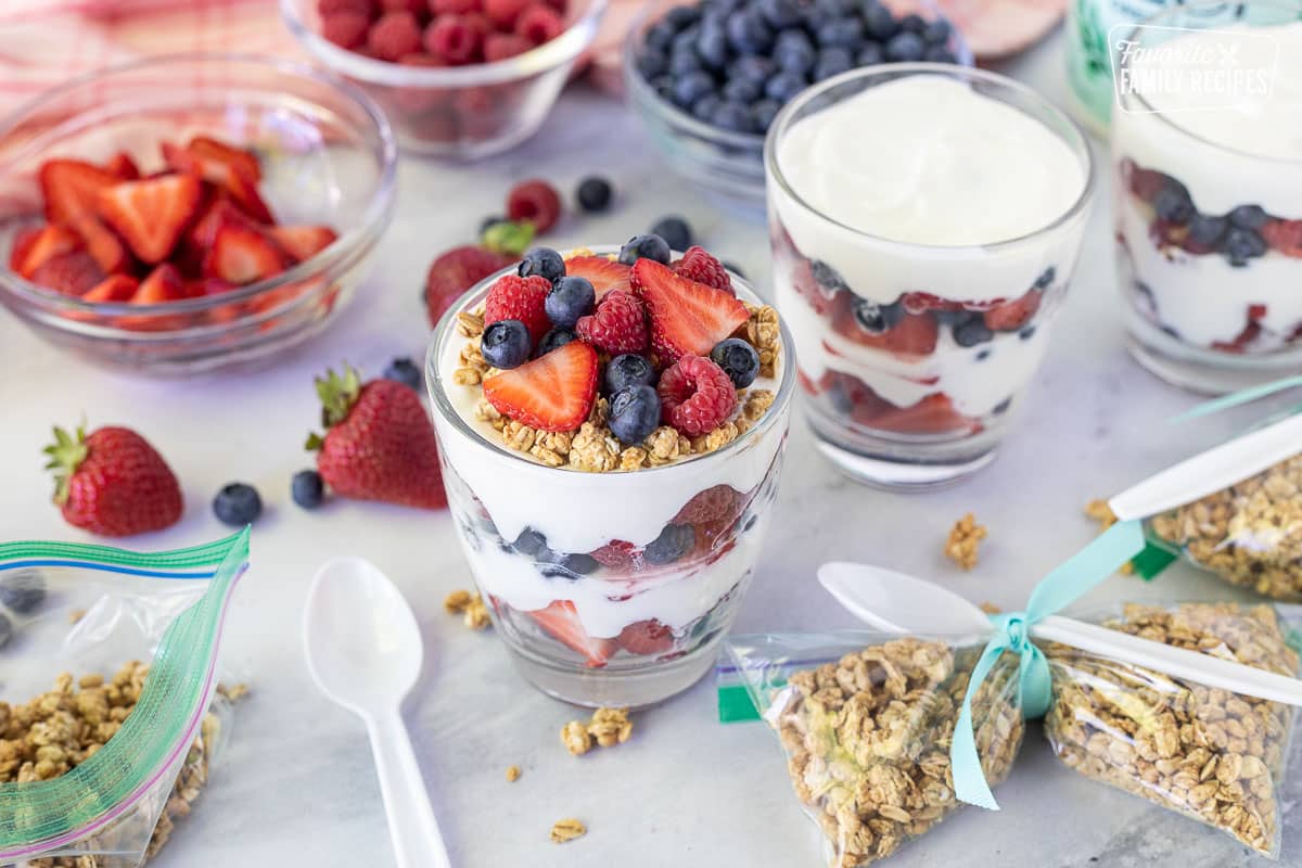 Cup of assembled Breakfast Parfait topped with granola and fresh berries.