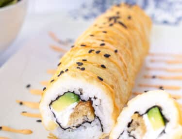 Shrimp Tempura Roll with spicy mayo and black sesame seeds.