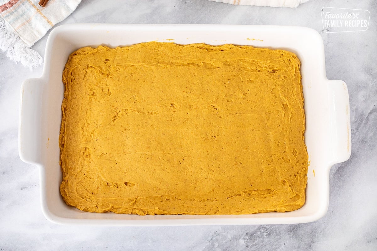 Baking dish with Pumpkin Poke Cake batter.