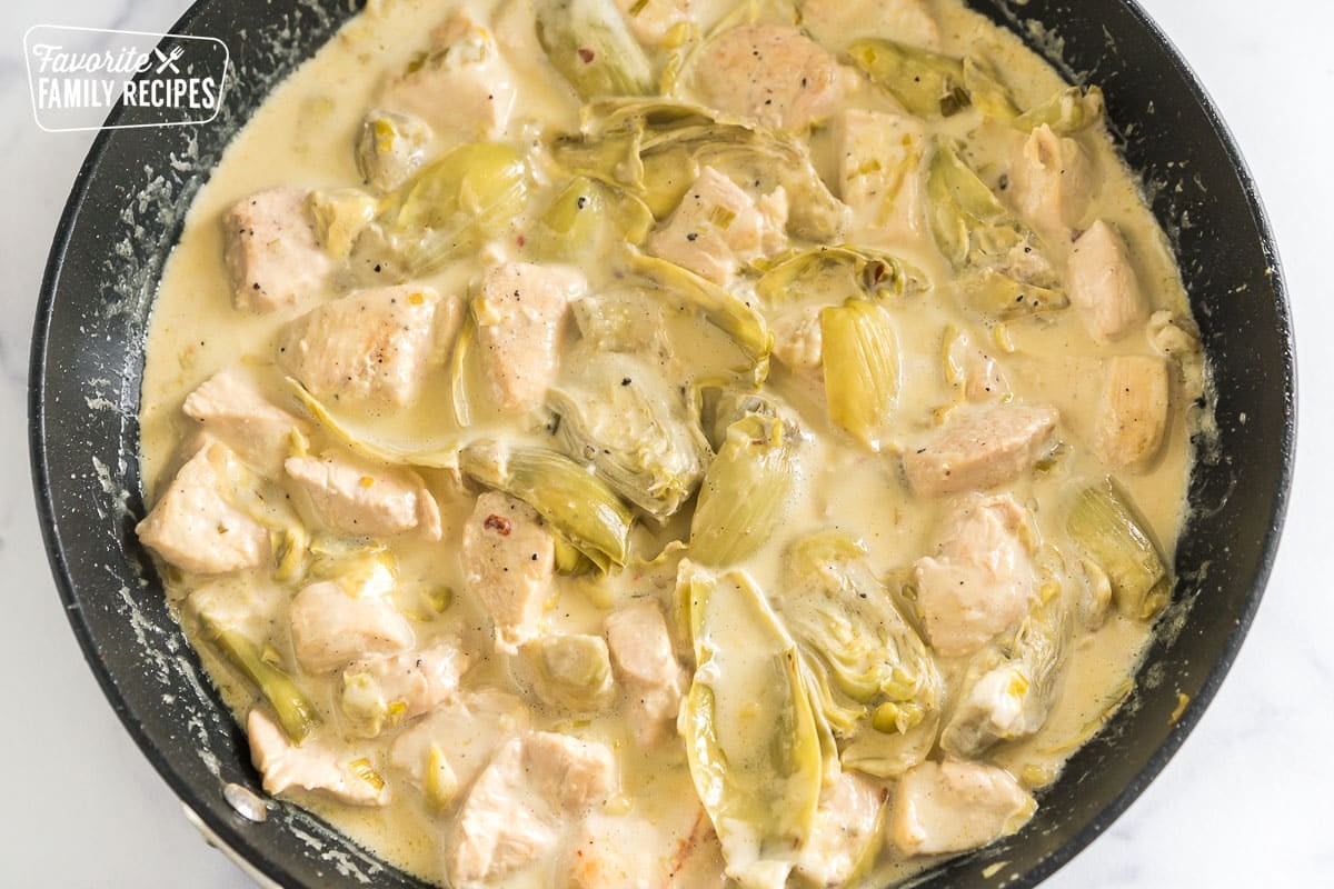 chicken and artichokes simmering in a cream sauce