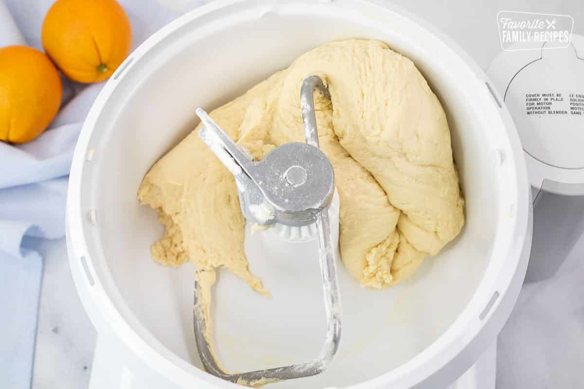 Mixer bowl with dough for Homemade Orange Rolls.