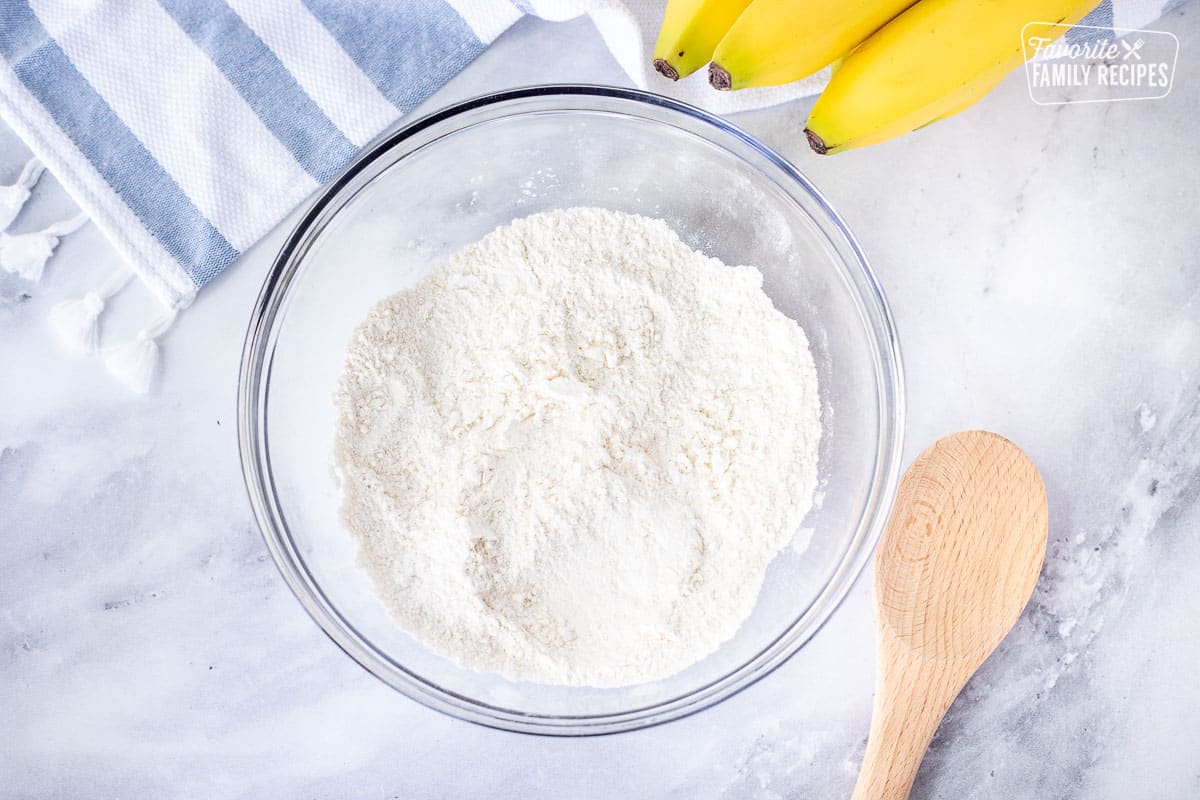 Mixing bowl with dry ingredients combined for Healthy Banana Muffins.