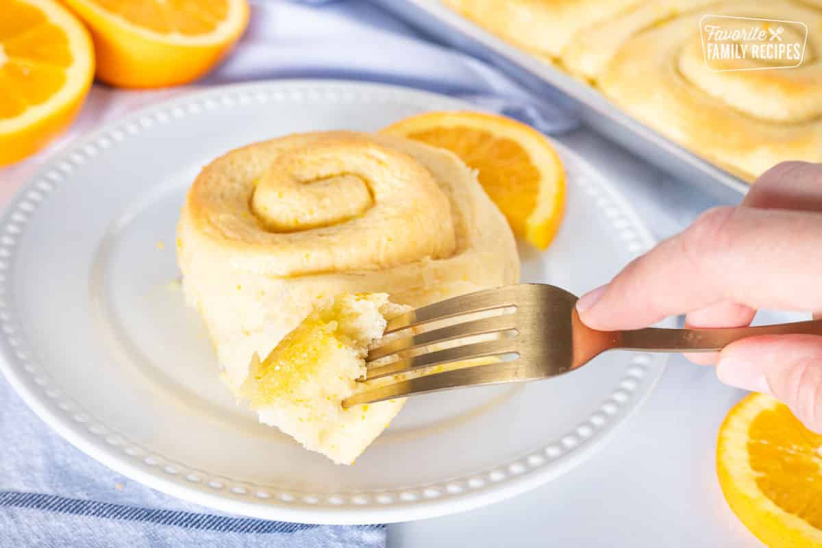 Fork holding a piece of a Homemade Orange Roll.