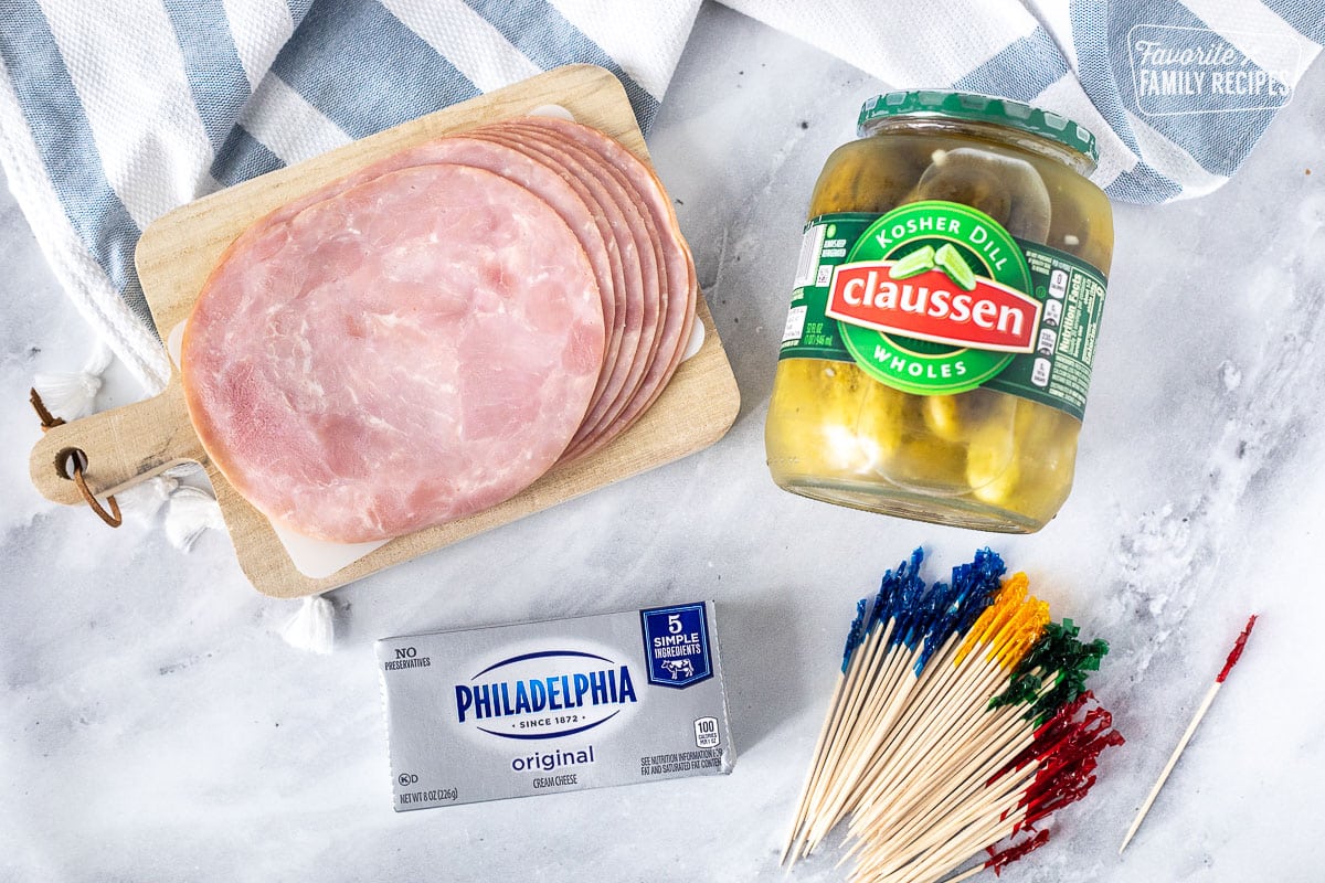 Ingredients for Ham Roll Up with Pickle including ham, pickles, cream cheese and toothpicks.