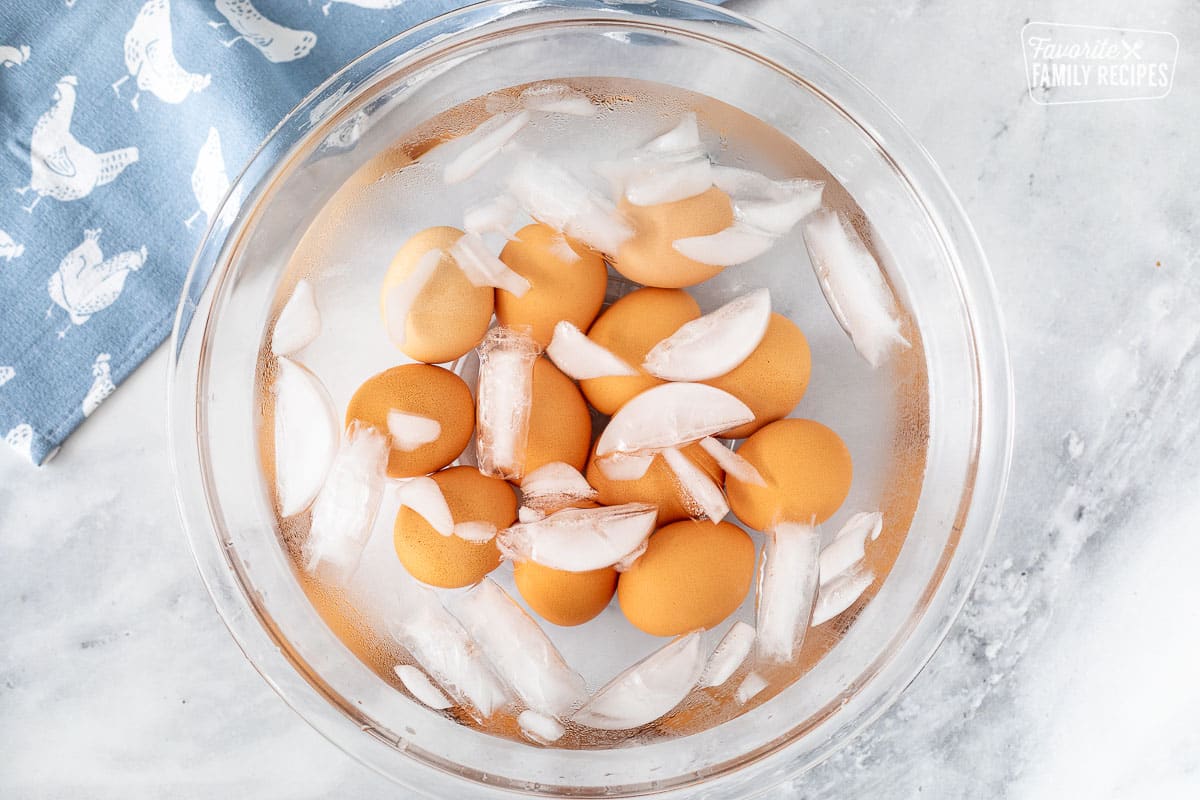Instant Pot Boiled Eggs cooling in a bowl of ice water.
