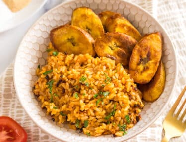 jollof rice in a bowl with fried plantains