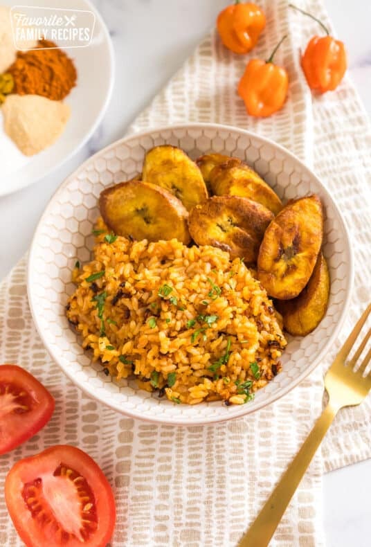 jollof rice in a bowl with fried plantains