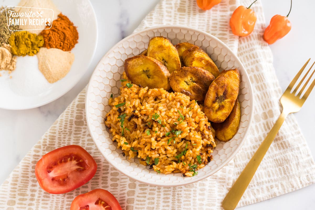 jollof rice in a bowl with fried plantains
