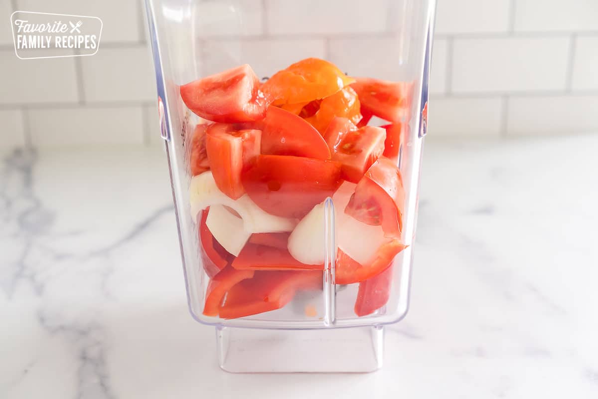 tomatoes, peppers, and onions in a blender before they are blended