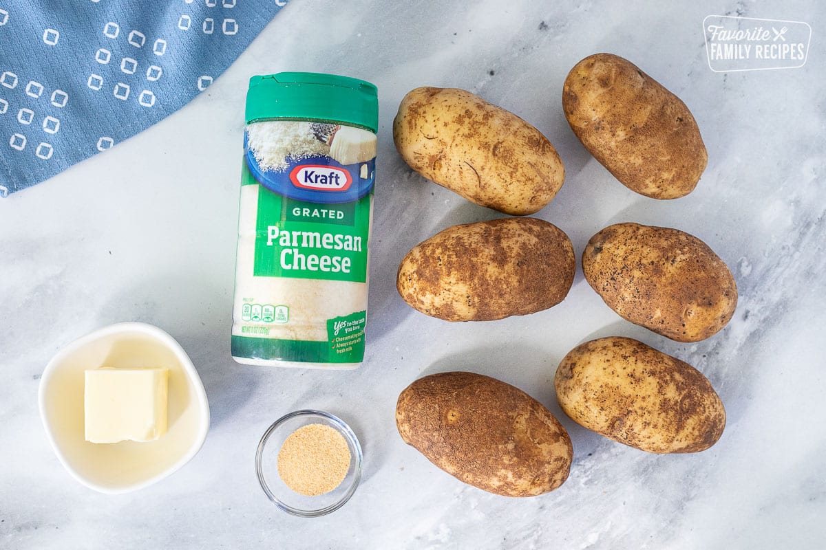 Ingredients for Parmesan Crusted Potatoes including Parmesan Cheese, potatoes, butter and garlic powder.