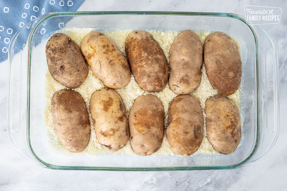 Baking dish with face down potato halves for Parmesan Crusted Potatoes.