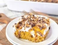 Pumpkin Poke Cake slice on a plate.