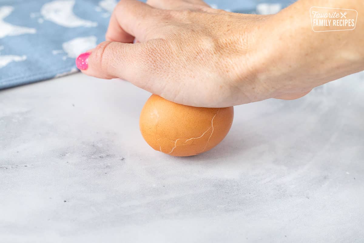 Hand rolling Instant Pot Hard Boiled Egg.