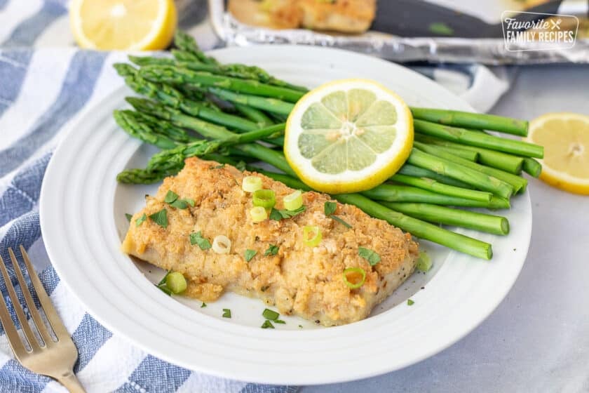 Plate with a fillet of Baked Mahi Mahi with Parmesan Crust. Asparagus on the side.