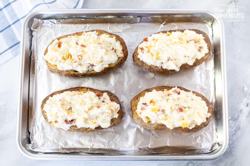 Baking dish with stuffed potatoes for Twice Baked Potatoes.