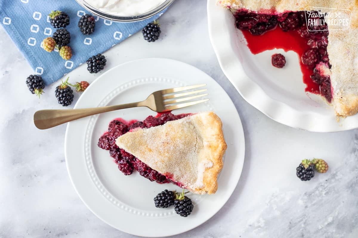Slice of Blackberry Pie on a plate with a fork.