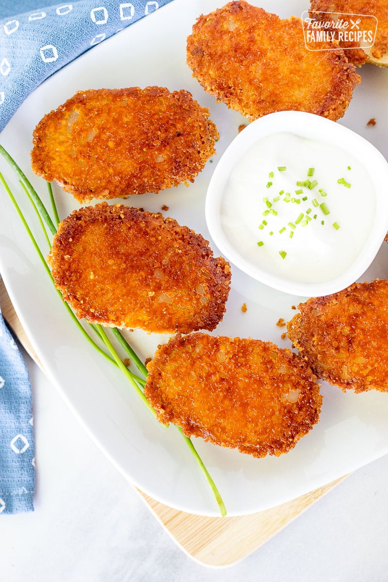 Platter of Parmesan Crusted Potatoes with sour cream.