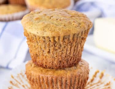 Two stacked Bran Muffins with liners removed.