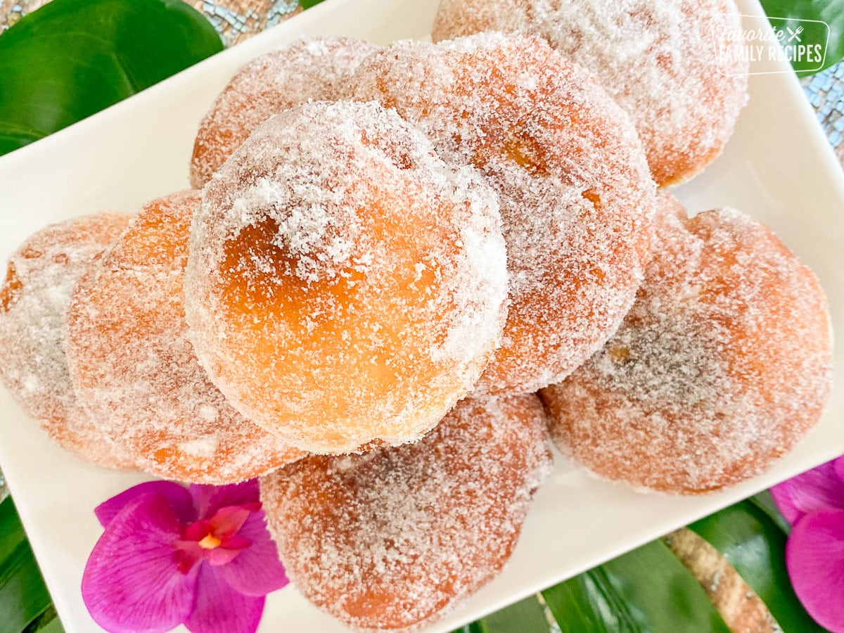 Top view of sugar coated Malasadas on a plate 
