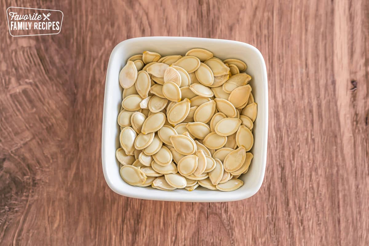 uncooked pumpkin seeds in a small bowl