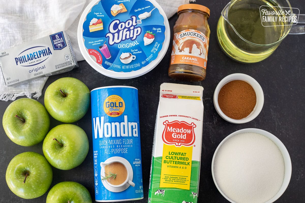 Ingredients to make Apple Fries including Cool Whip, cream cheese, caramel sauce, buttermilk, Wondra, apples, cinnamon, sugar and oil.