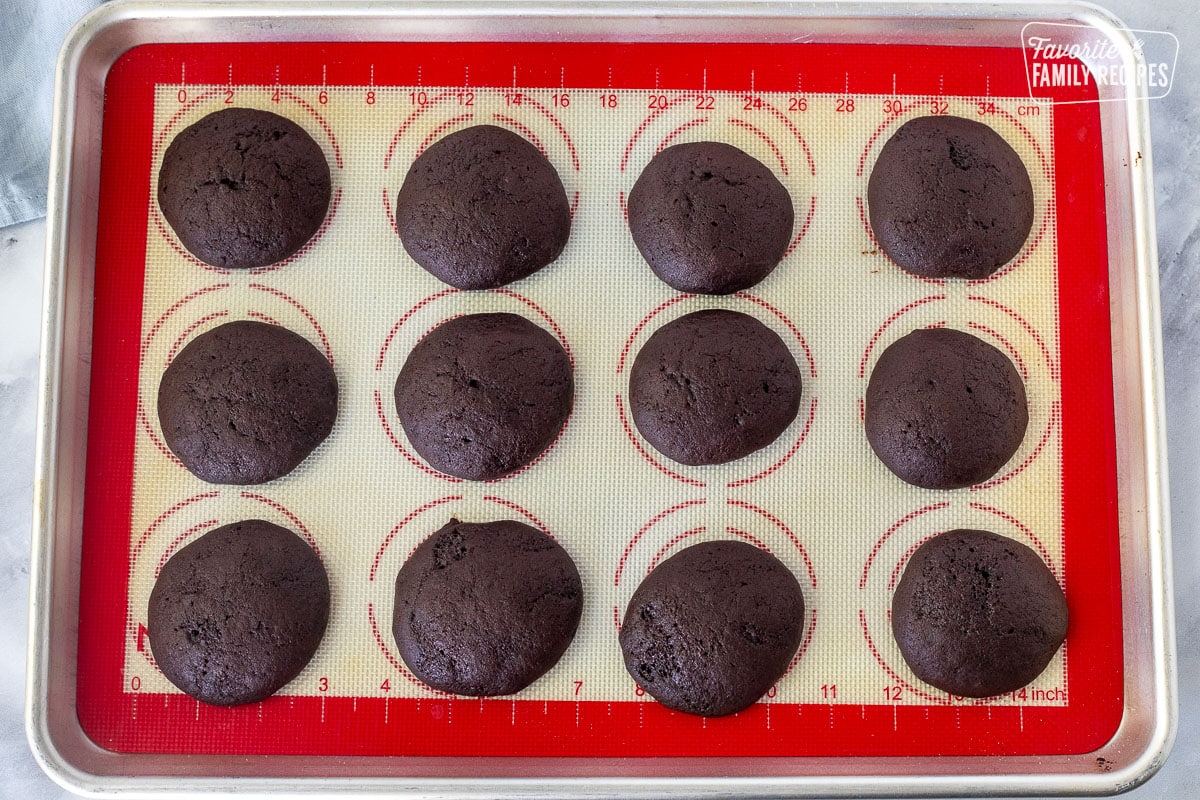 Baked Whoopie Pie cookies on a baking sheet with a silicone mat.