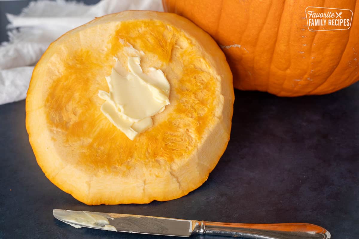 Spreading butter on the top of the cut out pumpkin for Soup.
