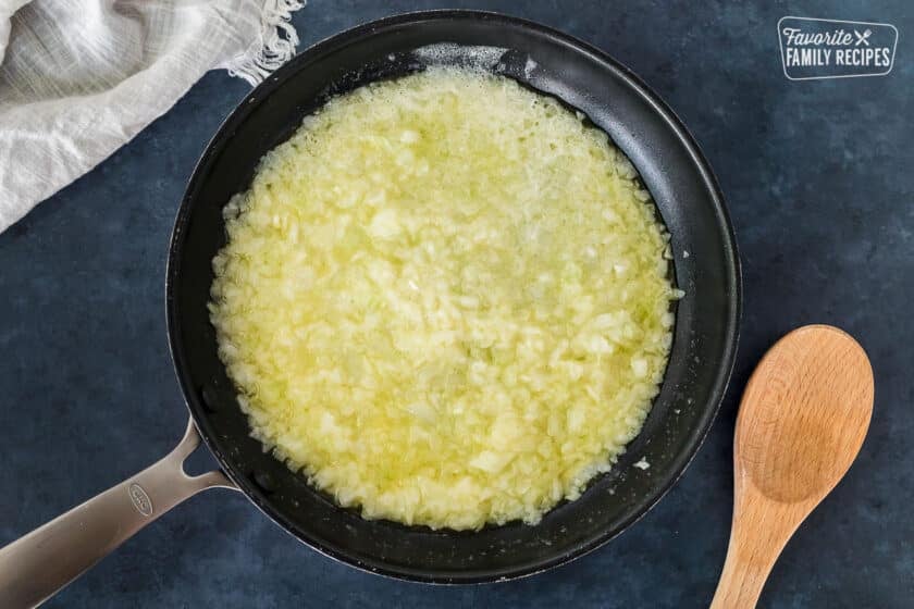 Skillet with butter and onion for soup in a Pumpkin.