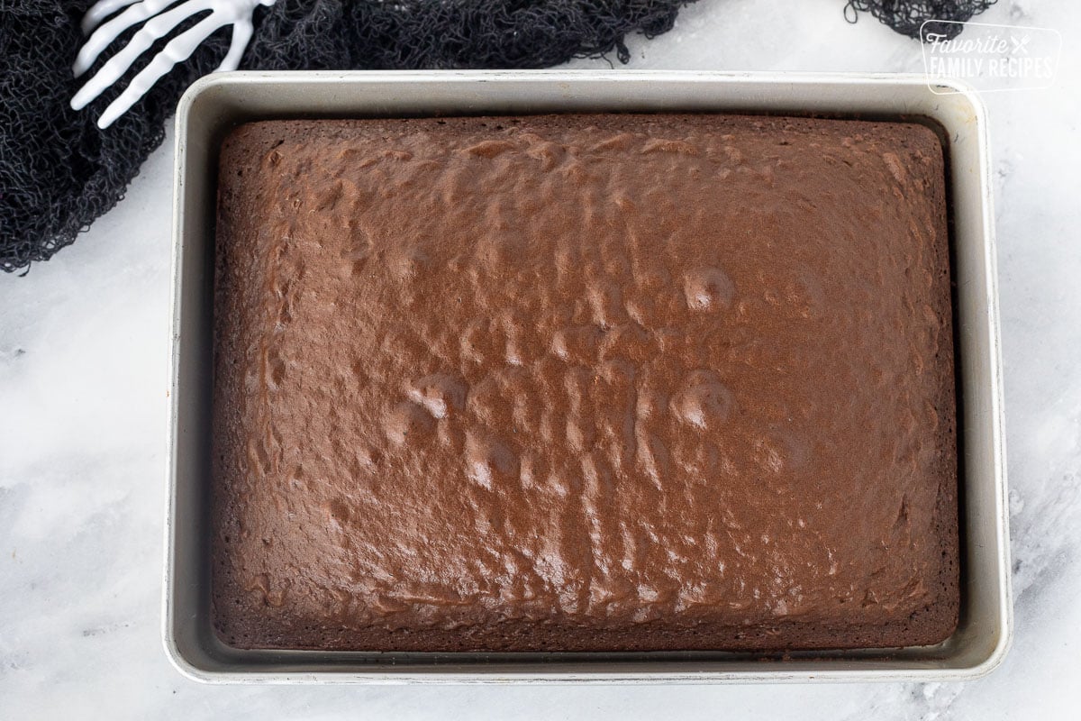 Baking pan with baked chocolate cake for Halloween Cake Pops.