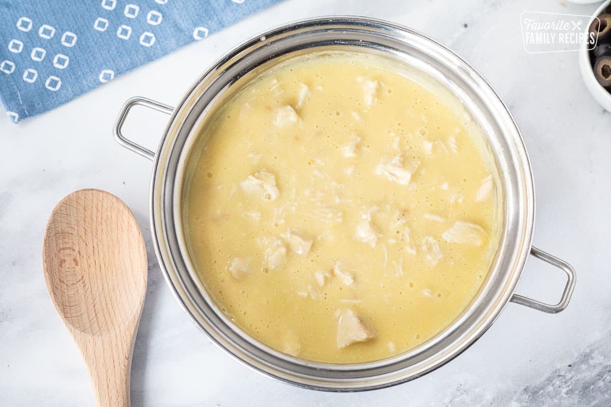 Pan of cream of chicken with chicken chunks and chicken broth for Hawaiian Haystacks.