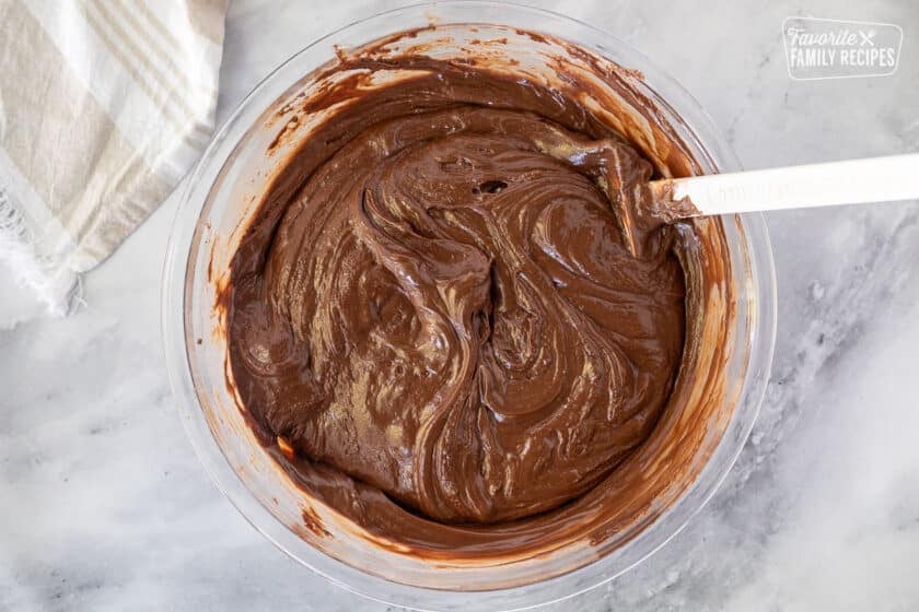 Stirred See's Fudge in a large glass bowl with spatula.