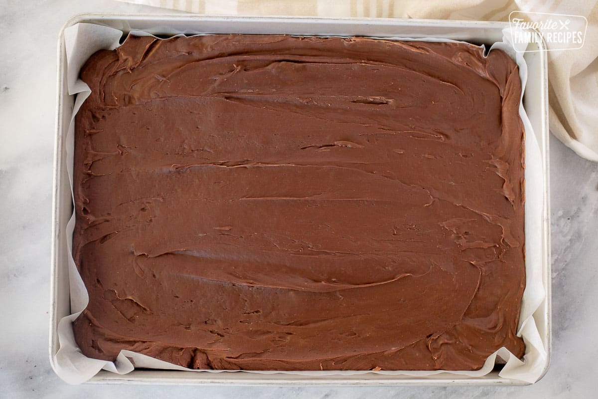 Cooled See's Fudge in a baking dish lined with parchment paper.