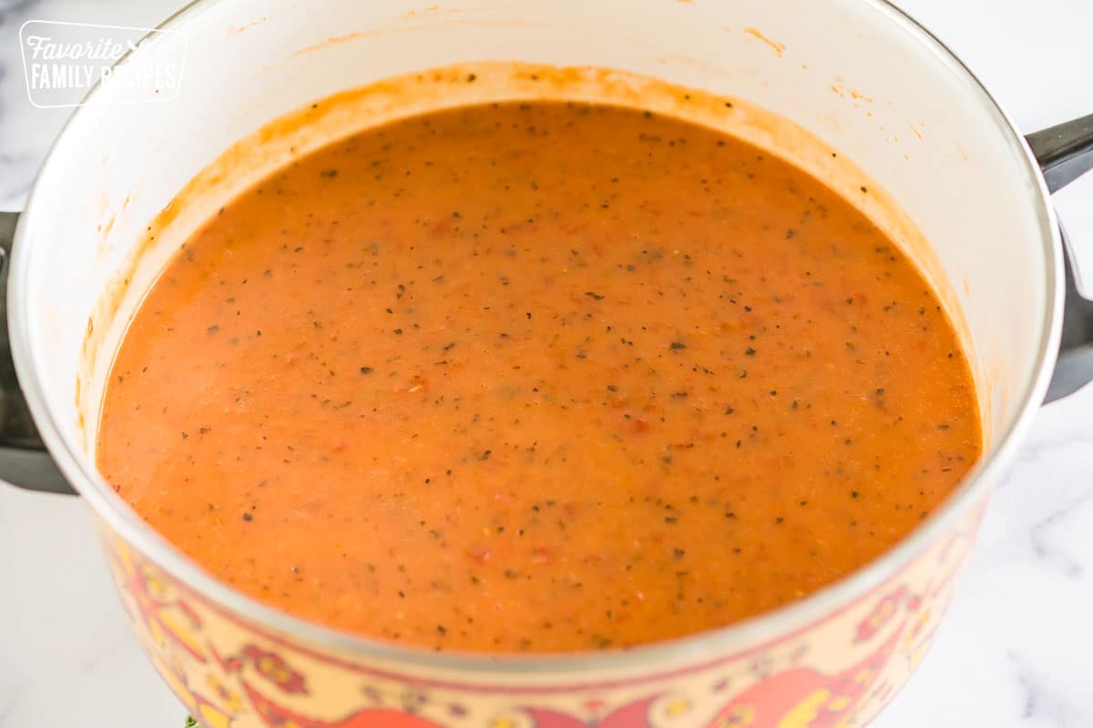 tomato soup in a pot before the sausage and cream get added