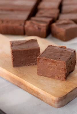 Cut pieces of See's Fudge on a cutter board.