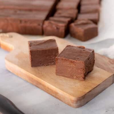 Cut pieces of See's Fudge on a cutter board.