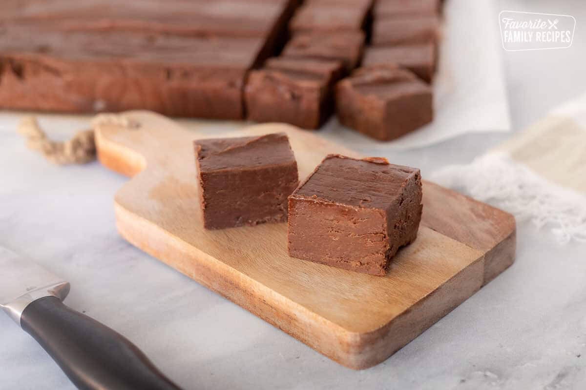Cut pieces of See's Fudge on a cutter board.