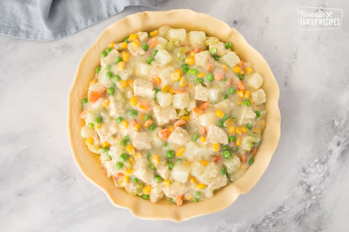Uncovered pie filled with Homemade Chicken Pot Pie filling.