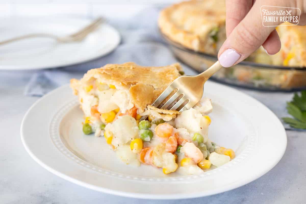 Fork cutting into a slice of Homemade Chicken Pot Pie.