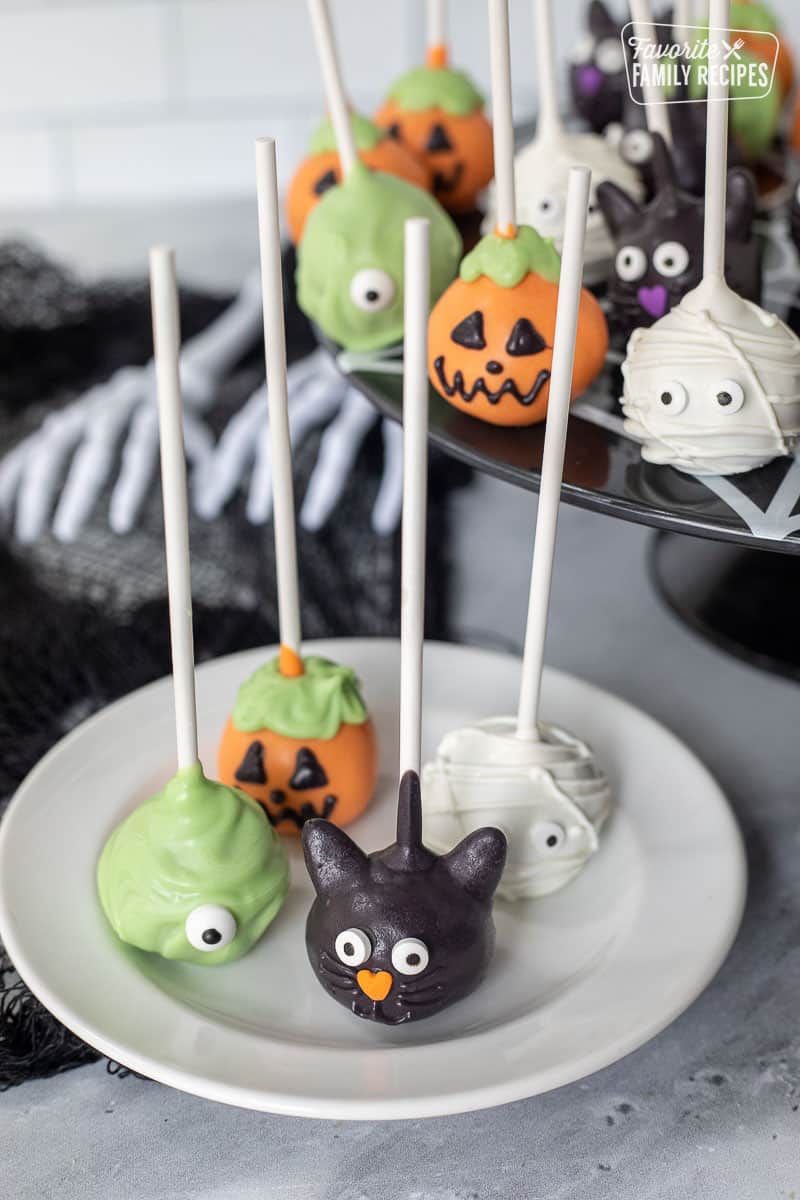 Plate with black cat, monster, mummy, and pumpkin Halloween Cake Pops.