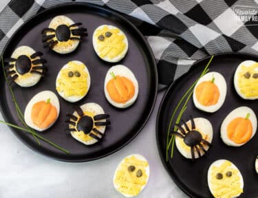 Halloween Deviled Eggs assorted on serving plates.