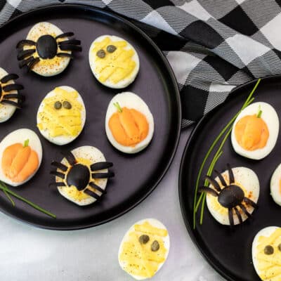 Halloween Deviled Eggs assorted on serving plates.