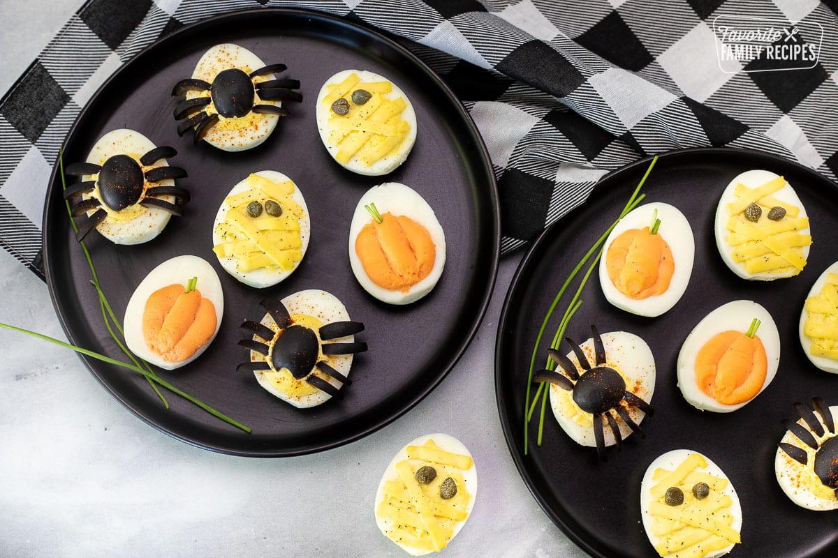 Halloween Deviled Eggs assorted on serving plates.