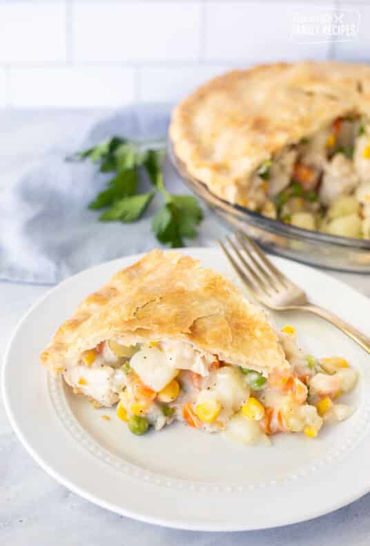 Homemade Chicken Pot Pie slice on a plate with a fork.
