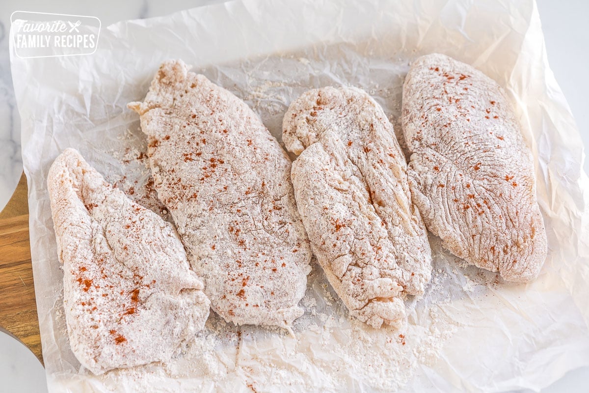 Four floured pieces of chicken