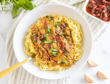 A bowl of pasta topped with cream sauce