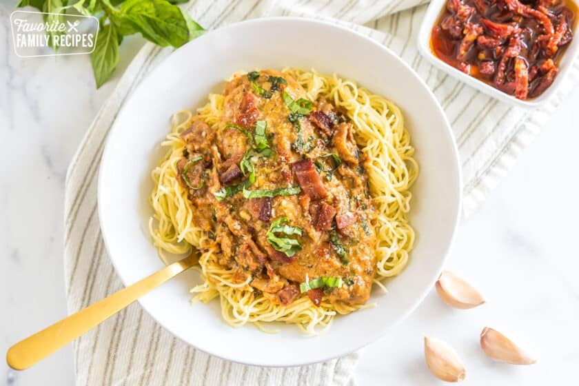 A bowl of pasta topped with cream sauce